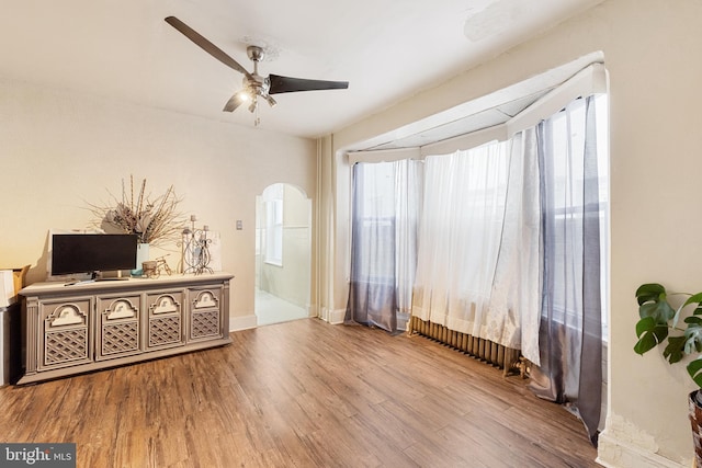 1419 Ellsworth St, Philadelphia, PA 19146 - unfurnished room with a ceiling fan, wood finished floors, arched walkways, and baseboards