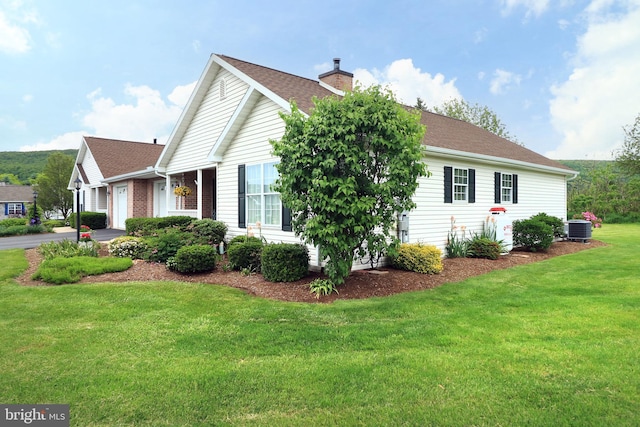 128 Penns Ct, Centre Hall, PA 16828 - view of property exterior featuring central AC, a yard, a chimney, an attached garage, and asphalt driveway