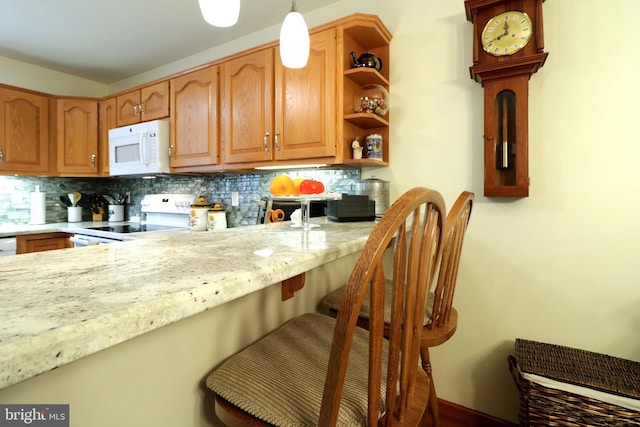 128 Penns Ct, Centre Hall, PA 16828 - kitchen featuring white appliances, decorative backsplash, a kitchen bar, open shelves, and light stone counters