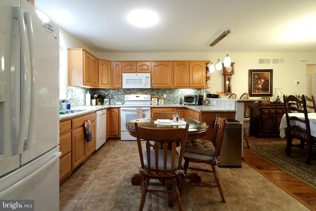128 Penns Ct, Centre Hall, PA 16828 - kitchen with white appliances, a peninsula, backsplash, and light countertops