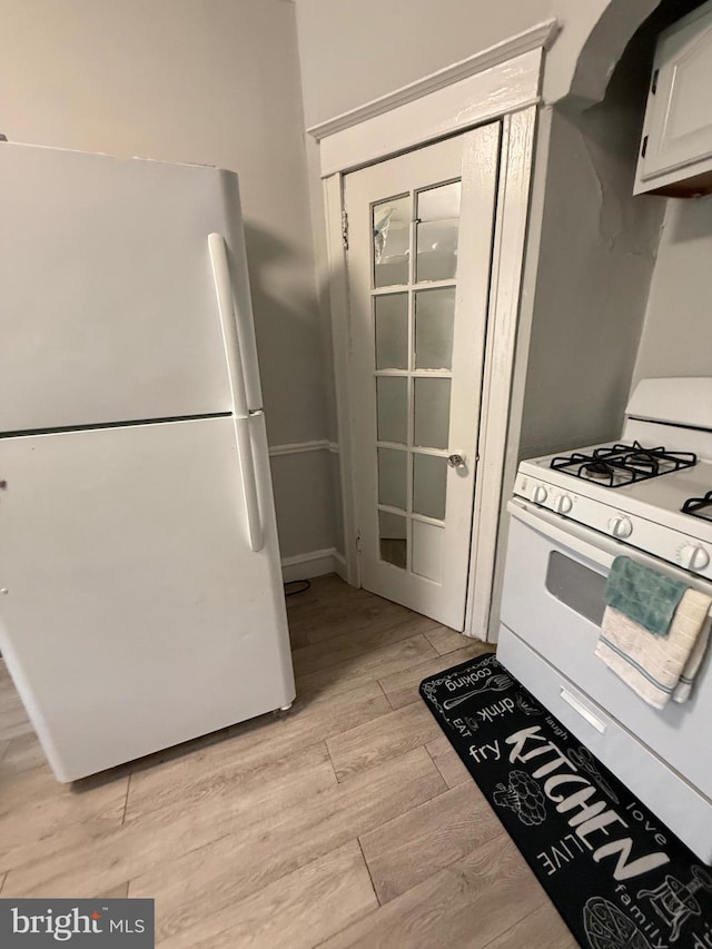 6412 N Sydenham St, Philadelphia, PA 19126 - kitchen with white appliances, light wood-style flooring, and white cabinetry