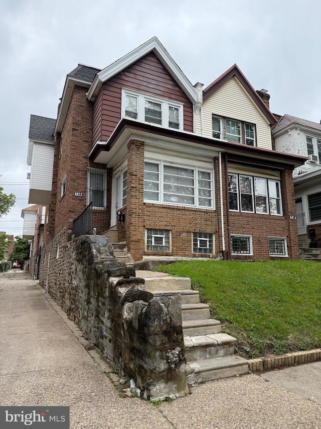 6412 N Sydenham St, Philadelphia, PA 19126 - view of front facade with a front yard and brick siding