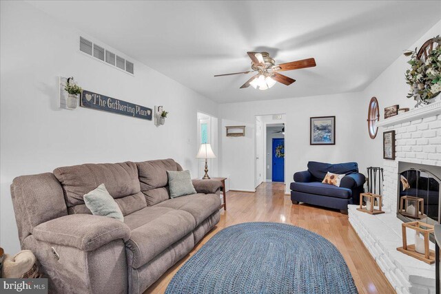 20 Laurel Dr, Tabernacle, NJ 08088 - living area with ceiling fan, light wood-style flooring, and a brick fireplace