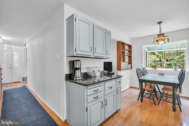 20 Laurel Dr, Tabernacle, NJ 08088 - kitchen with light wood-style floors, healthy amount of natural light, dark stone counters, and baseboards