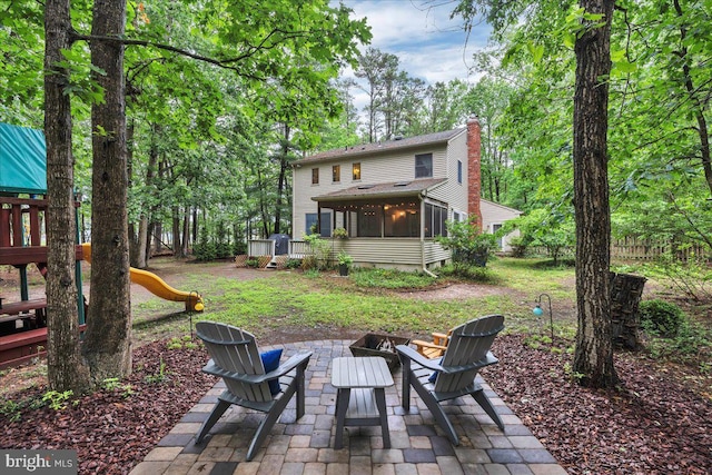 20 Laurel Dr, Tabernacle, NJ 08088 - back of house featuring a playground, a sunroom, a patio, and a chimney