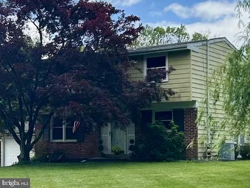 1590 Daws Rd, Blue Bell, PA 19422 - view of front of property with a front lawn, brick siding, and a garage