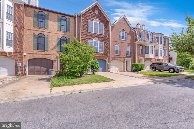 6 Victoria Sq, Frederick, MD 21702 - townhome / multi-family property with driveway, a garage, and brick siding
