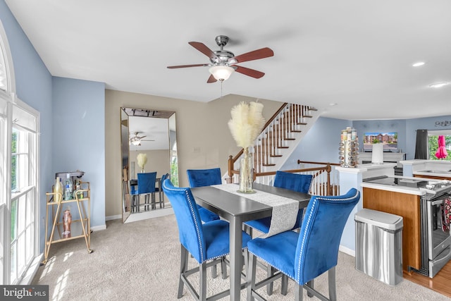 6 Victoria Sq, Frederick, MD 21702 - dining room featuring ceiling fan, light colored carpet, baseboards, and stairs