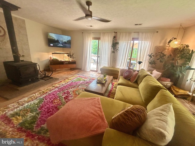 415 Rolly Rd, Mount Jackson, VA 22842 - living area with wood finished floors, ceiling fan, a textured ceiling, and a wood stove