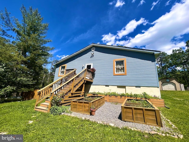 415 Rolly Rd, Mount Jackson, VA 22842 - rear view of house featuring a garden, a lawn, stairs, and an outdoor structure