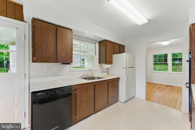 13021 Morningside Ln, Silver Spring, MD 20904 - kitchen featuring dishwasher, a sink, light countertops, light flooring, and freestanding refrigerator