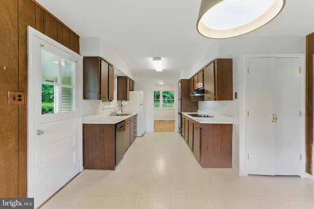 13021 Morningside Ln, Silver Spring, MD 20904 - kitchen featuring under cabinet range hood, appliances with stainless steel finishes, light countertops, and light flooring
