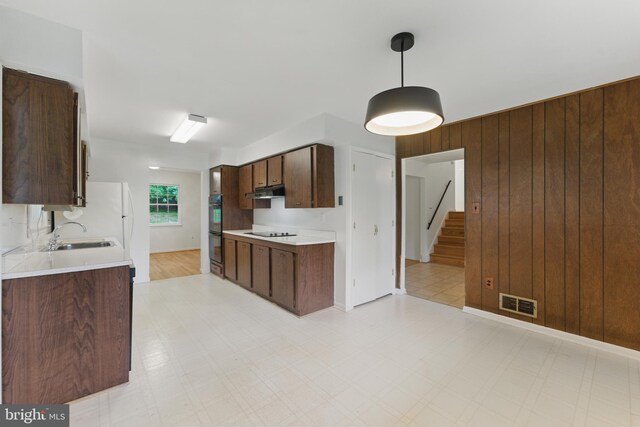 13021 Morningside Ln, Silver Spring, MD 20904 - kitchen with a sink, black appliances, light countertops, light floors, and dark brown cabinetry