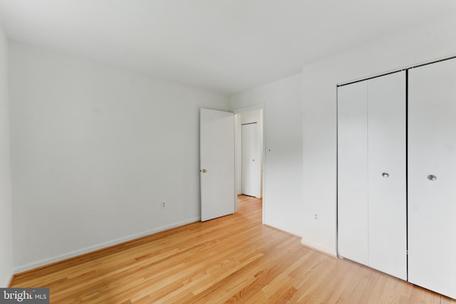 13021 Morningside Ln, Silver Spring, MD 20904 - unfurnished bedroom featuring wood finished floors, a closet, and baseboards