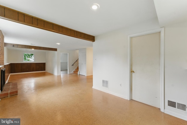 13021 Morningside Ln, Silver Spring, MD 20904 - unfurnished living room featuring stairs, a brick fireplace, baseboards, recessed lighting, and wood walls