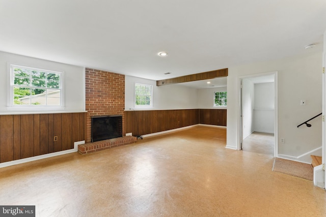 13021 Morningside Ln, Silver Spring, MD 20904 - unfurnished living room featuring wainscoting, tile patterned floors, wood walls, and a brick fireplace