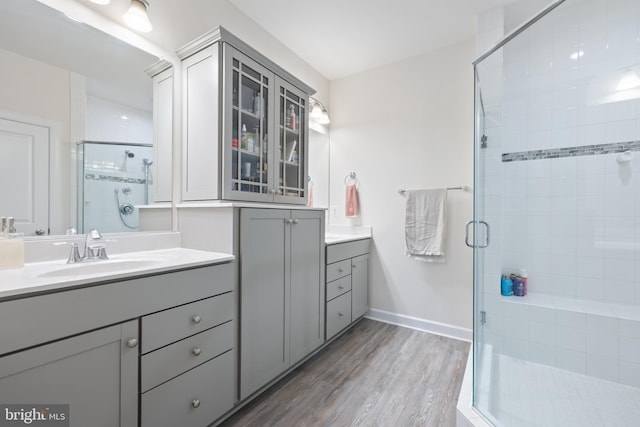 12363 Azure Ln Unit 42, Fairfax, VA 22033 - full bath with a shower stall, vanity, wood finished floors, and baseboards