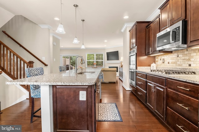 14039 Fox Hill Rd, Sparks, MD 21152 - kitchen featuring a sink, appliances with stainless steel finishes, a breakfast bar area, dark wood-style floors, and tasteful backsplash