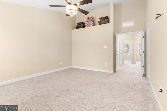 14039 Fox Hill Rd, Sparks, MD 21152 - spare room featuring light colored carpet, ceiling fan, baseboards, and a towering ceiling