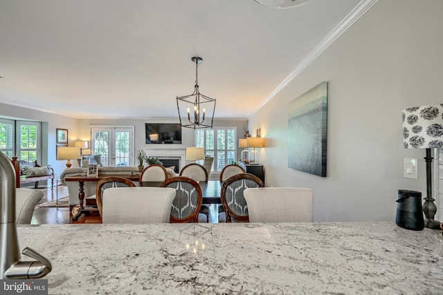 11920 Mays Chapel Rd, Lutherville Timonium, MD 21093 - dining room featuring crown molding, a fireplace, wood finished floors, and a chandelier