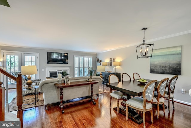 11920 Mays Chapel Rd, Lutherville Timonium, MD 21093 - dining area featuring crown molding, plenty of natural light, a chandelier, hardwood / wood-style floors, and a fireplace