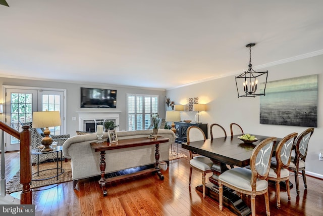11920 Mays Chapel Rd, Lutherville Timonium, MD 21093 - dining area featuring crown molding, plenty of natural light, a chandelier, and hardwood / wood-style floors