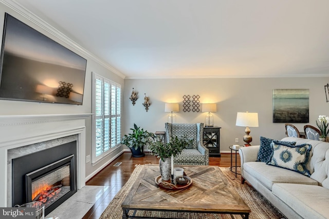 11920 Mays Chapel Rd, Lutherville Timonium, MD 21093 - living area featuring ornamental molding, a fireplace with flush hearth, wood finished floors, and baseboards