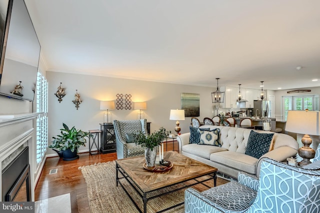 11920 Mays Chapel Rd, Lutherville Timonium, MD 21093 - living room featuring a fireplace with flush hearth, dark wood-style floors, ornamental molding, baseboards, and recessed lighting
