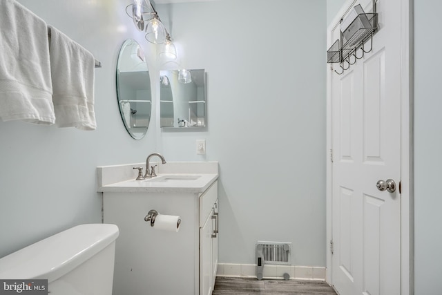 11920 Mays Chapel Rd, Lutherville Timonium, MD 21093 - bathroom with vanity, toilet, and wood finished floors