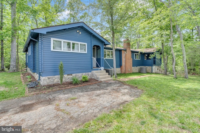 11621 Deadwood Dr, Lusby, MD 20657 - view of front facade with a front yard, central air condition unit, and crawl space