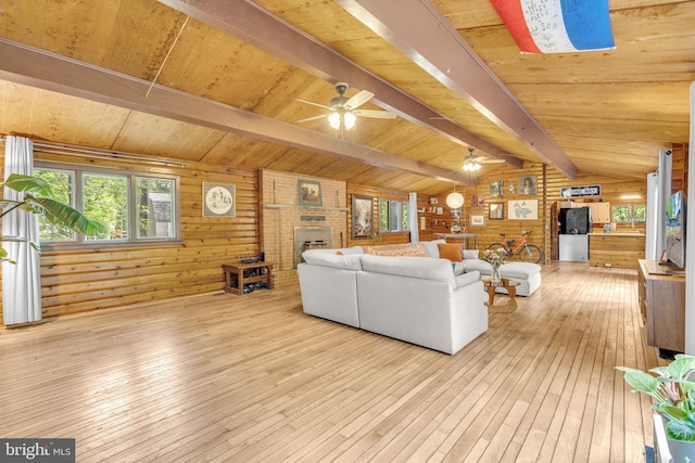 11621 Deadwood Dr, Lusby, MD 20657 - living area featuring wood-type flooring, wood walls, a brick fireplace, wooden ceiling, and a ceiling fan