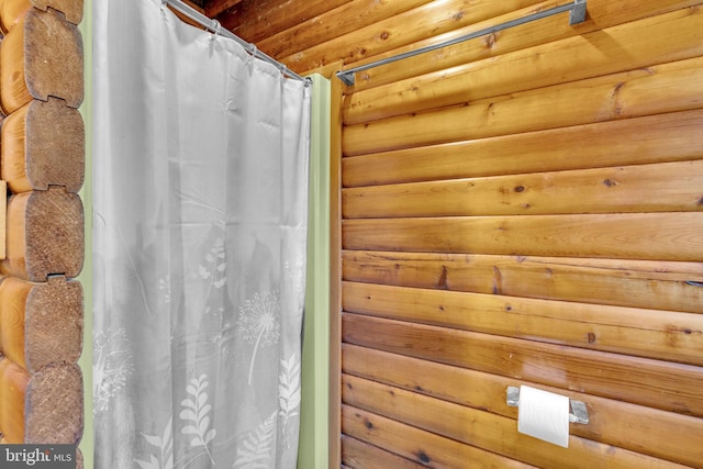 11621 Deadwood Dr, Lusby, MD 20657 - bathroom with rustic walls and a shower with shower curtain