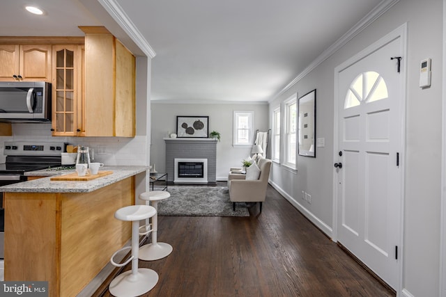 609 Eldrid Dr, Silver Spring, MD 20904 - kitchen with appliances with stainless steel finishes, a breakfast bar area, glass insert cabinets, dark wood-type flooring, and crown molding