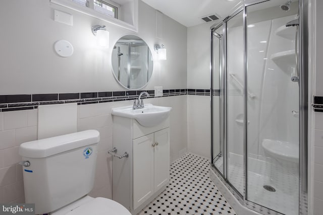 609 Eldrid Dr, Silver Spring, MD 20904 - full bath featuring toilet, a stall shower, vanity, tile walls, and wainscoting