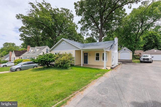 609 Eldrid Dr, Silver Spring, MD 20904 - view of front facade with a front yard, a detached garage, an outdoor structure, and a chimney