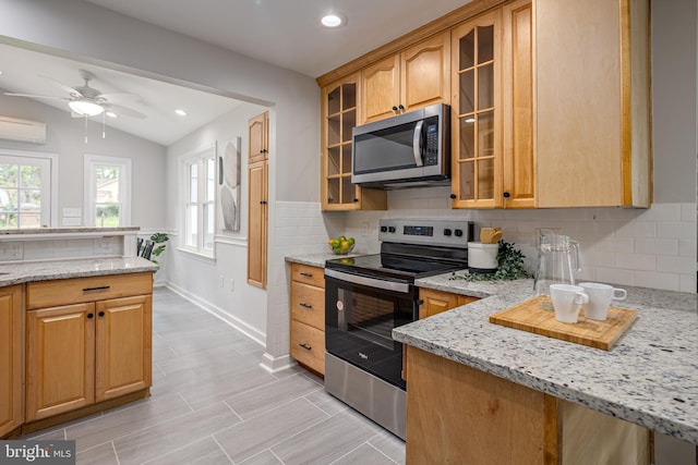 609 Eldrid Dr, Silver Spring, MD 20904 - kitchen with appliances with stainless steel finishes, a wall mounted air conditioner, light stone counters, backsplash, and recessed lighting