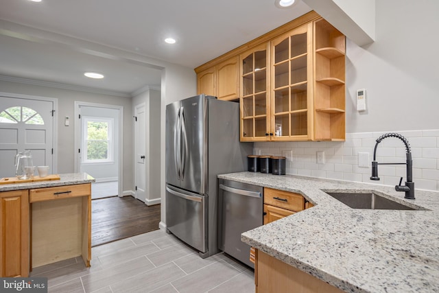 609 Eldrid Dr, Silver Spring, MD 20904 - kitchen featuring stainless steel appliances, a sink, ornamental molding, light stone countertops, and glass insert cabinets