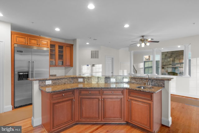 14603 Turner Wootton Pkwy, Upper Marlboro, MD 20774 - kitchen with stainless steel built in fridge, a sink, a ceiling fan, light wood finished floors, and brown cabinets