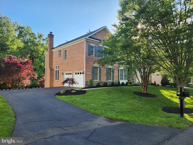 14603 Turner Wootton Pkwy, Upper Marlboro, MD 20774 - view of front of property with driveway, an attached garage, a chimney, brick siding, and a front yard
