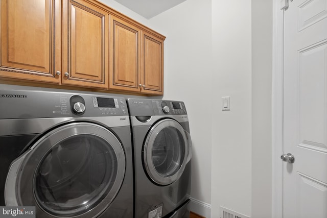 14603 Turner Wootton Pkwy, Upper Marlboro, MD 20774 - washroom featuring washing machine and clothes dryer, cabinet space, and baseboards
