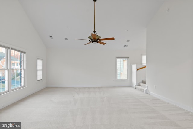14603 Turner Wootton Pkwy, Upper Marlboro, MD 20774 - unfurnished living room with high vaulted ceiling, plenty of natural light, stairs, light carpet, and ceiling fan