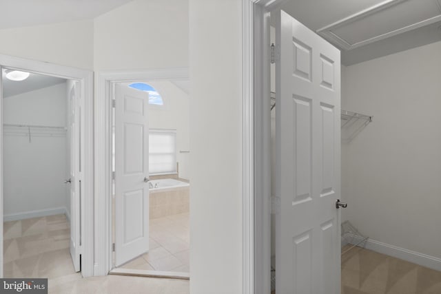 14603 Turner Wootton Pkwy, Upper Marlboro, MD 20774 - full bath featuring a garden tub, a spacious closet, vaulted ceiling, and baseboards