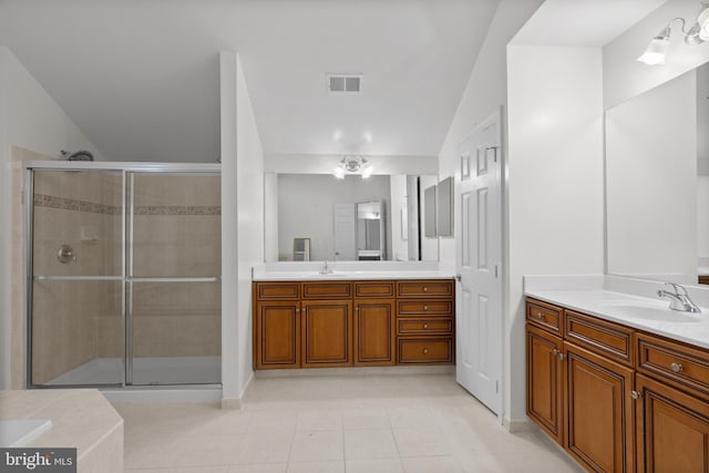 14603 Turner Wootton Pkwy, Upper Marlboro, MD 20774 - bathroom featuring lofted ceiling, a stall shower, two vanities, and tile patterned flooring