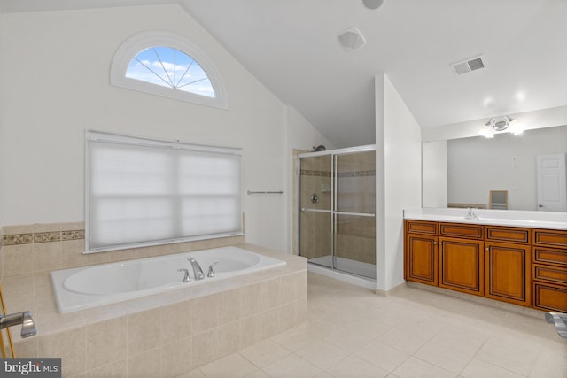 14603 Turner Wootton Pkwy, Upper Marlboro, MD 20774 - bathroom with vaulted ceiling, a bath, vanity, a stall shower, and tile patterned floors
