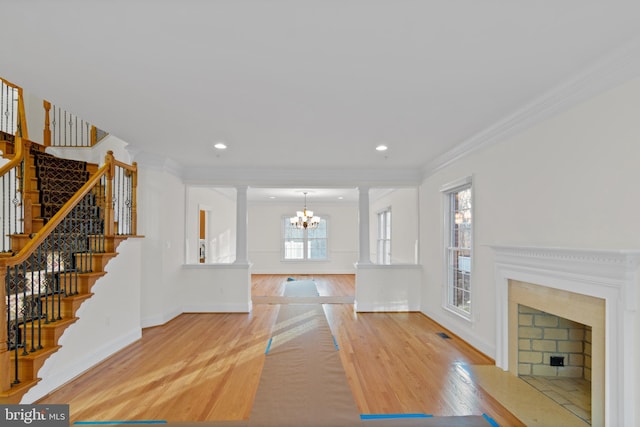 14603 Turner Wootton Pkwy, Upper Marlboro, MD 20774 - unfurnished living room featuring a fireplace with flush hearth, wood finished floors, a chandelier, ornamental molding, and stairs