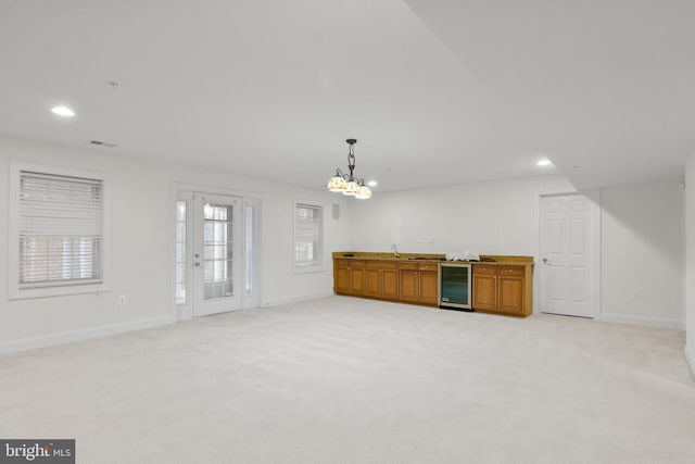 14603 Turner Wootton Pkwy, Upper Marlboro, MD 20774 - unfurnished living room featuring beverage cooler, baseboards, recessed lighting, a chandelier, and a sink