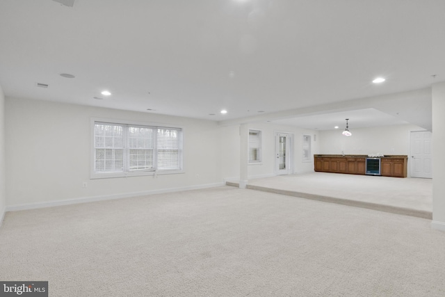 14603 Turner Wootton Pkwy, Upper Marlboro, MD 20774 - unfurnished living room featuring wine cooler, recessed lighting, light colored carpet, and baseboards