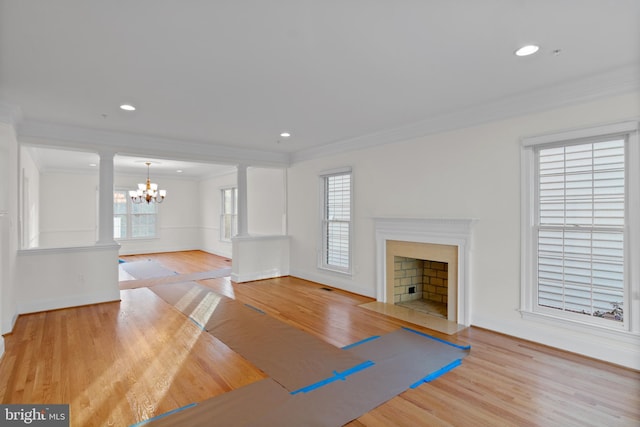 14603 Turner Wootton Pkwy, Upper Marlboro, MD 20774 - unfurnished living room featuring ornate columns, ornamental molding, wood finished floors, baseboards, and plenty of natural light