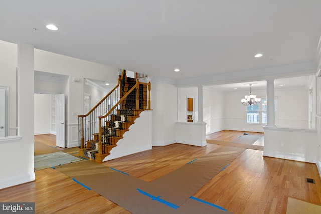 14603 Turner Wootton Pkwy, Upper Marlboro, MD 20774 - foyer entrance featuring ornamental molding, a chandelier, ornate columns, wood finished floors, and stairway