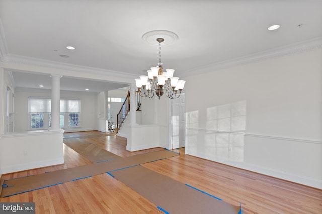 14603 Turner Wootton Pkwy, Upper Marlboro, MD 20774 - unfurnished dining area with crown molding, a chandelier, stairway, ornate columns, and baseboards
